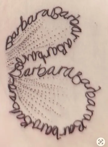 Two-part heart tattoo made of a loved one's name